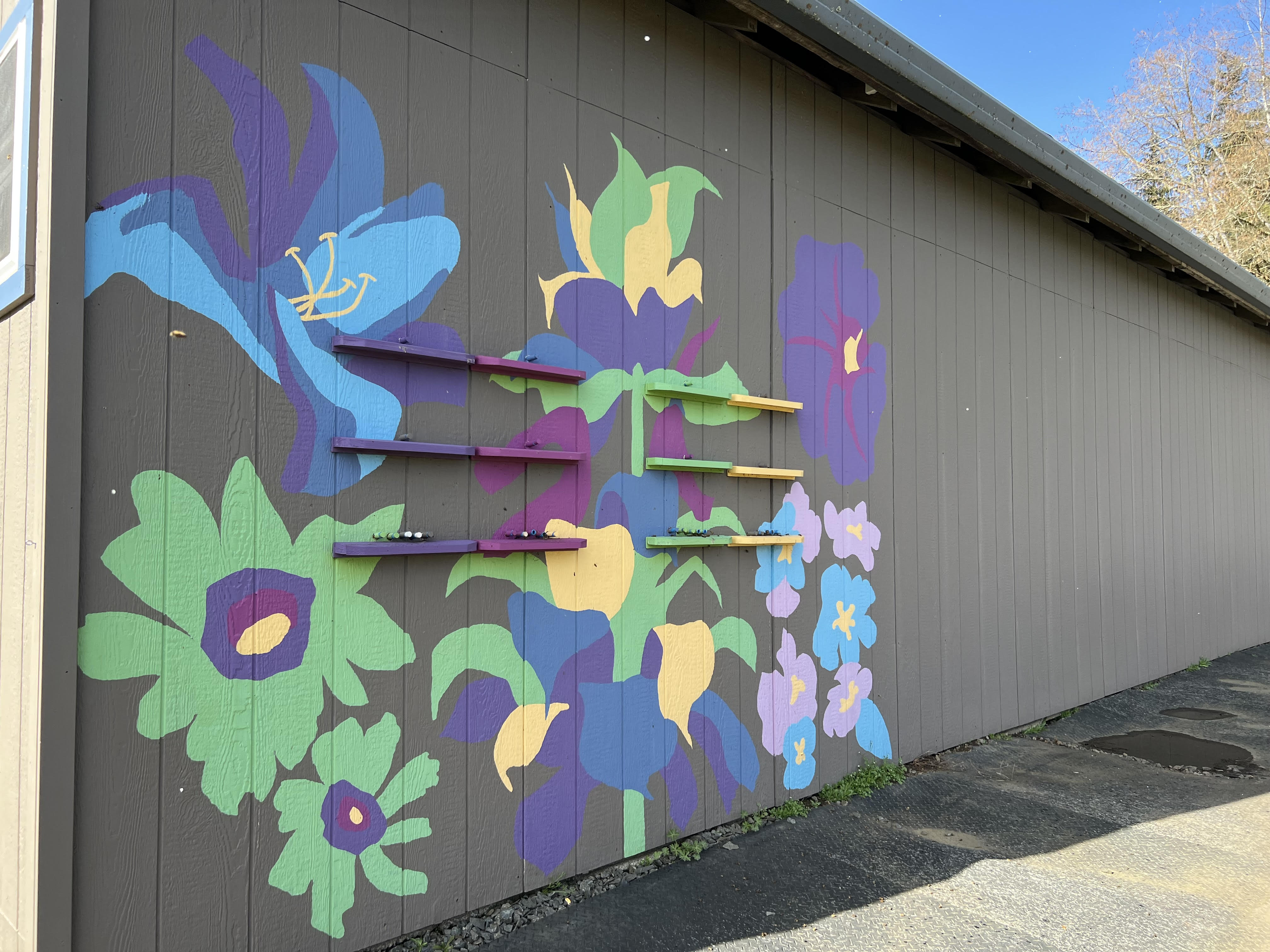 Colored entrance to a building, within which are Slovenian or AZ hives; photo by Dewey M. Caron